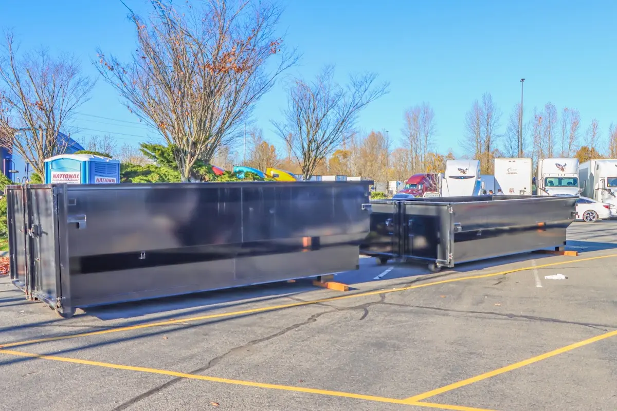 Professional dumpster rental service with roll-off container on residential driveway in Abbeville